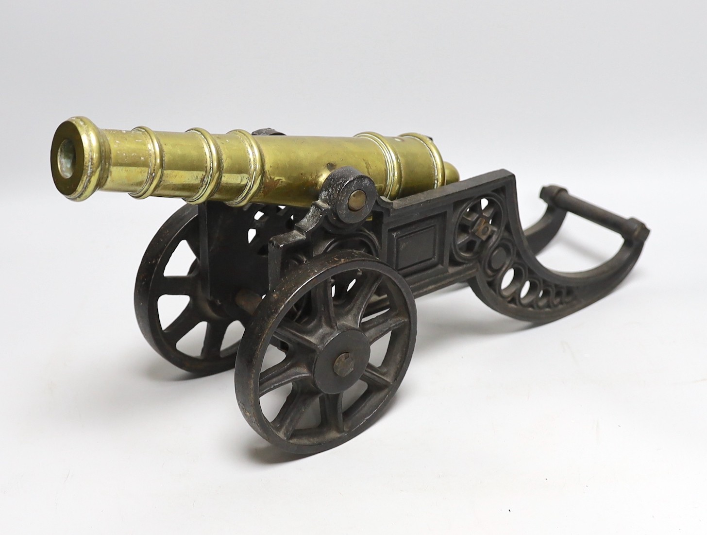 A cast iron and brass model cannon, 47cm long